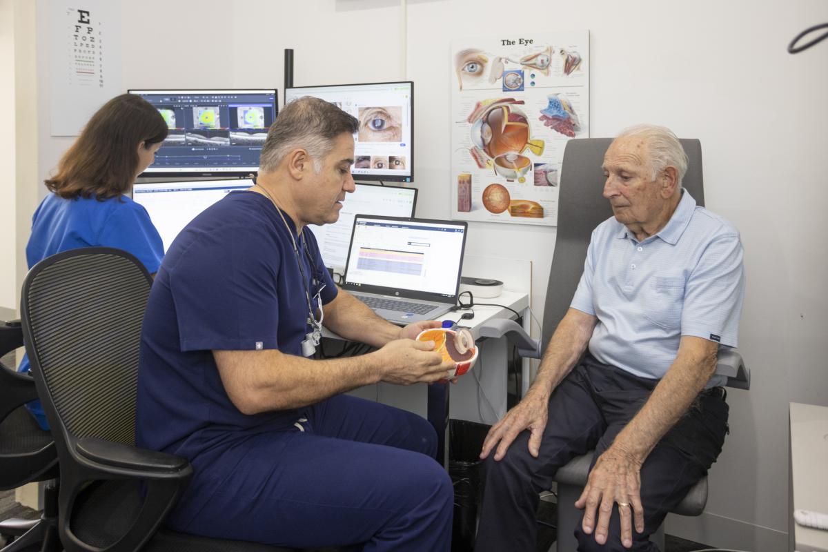 Ophthalmologist explaining an eye model to a patient in clinic